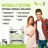 Scoop of VITINITY Bovine Colostrum Powder on a wooden spoon