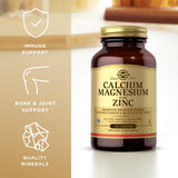 Solgar Calcium Magnesium Plus Zinc tablets on a wooden table