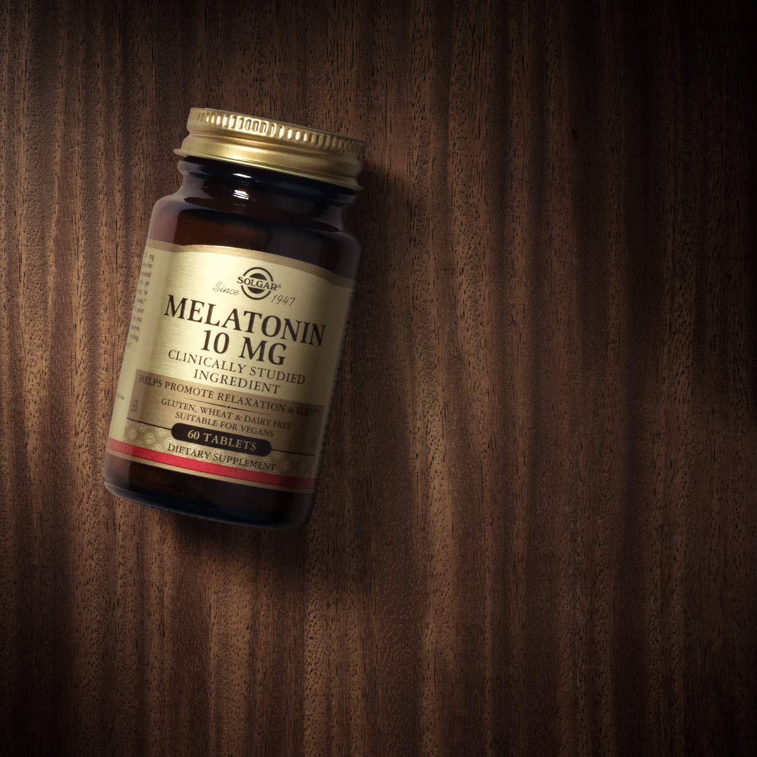 Solgar Melatonin 10mg 60 Tablets on a wooden surface