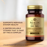 Solgar Niacin B3 100mg Supplement capsules on a wooden surface