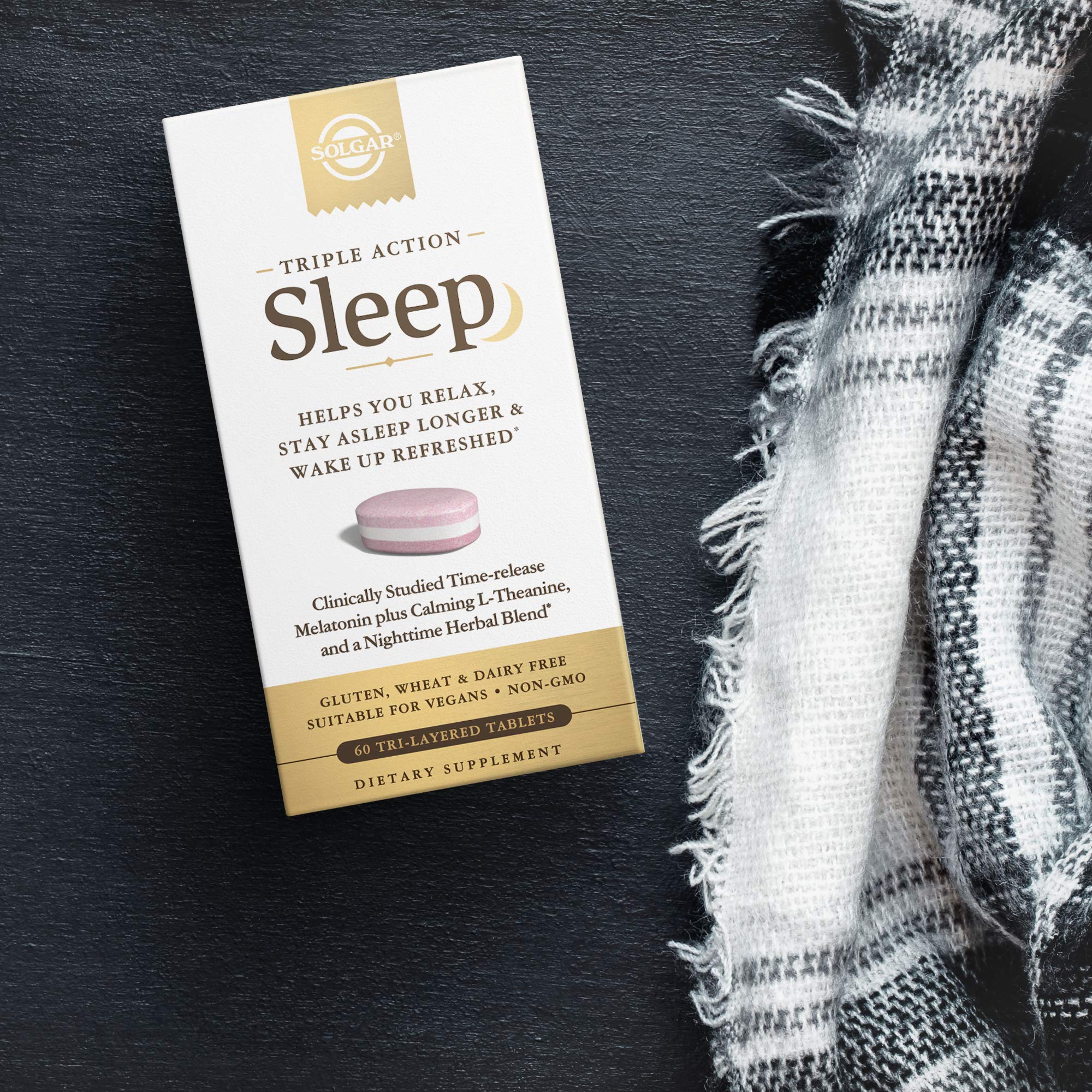 Solgar Triple Action Sleep Supplement on a wooden table
