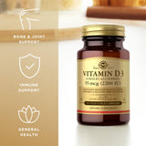 Solgar Vitamin D3 2200 IU Vegetable Capsules on a wooden surface