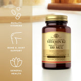 Solgar Vitamin K2 100mcg Capsules on a wooden table