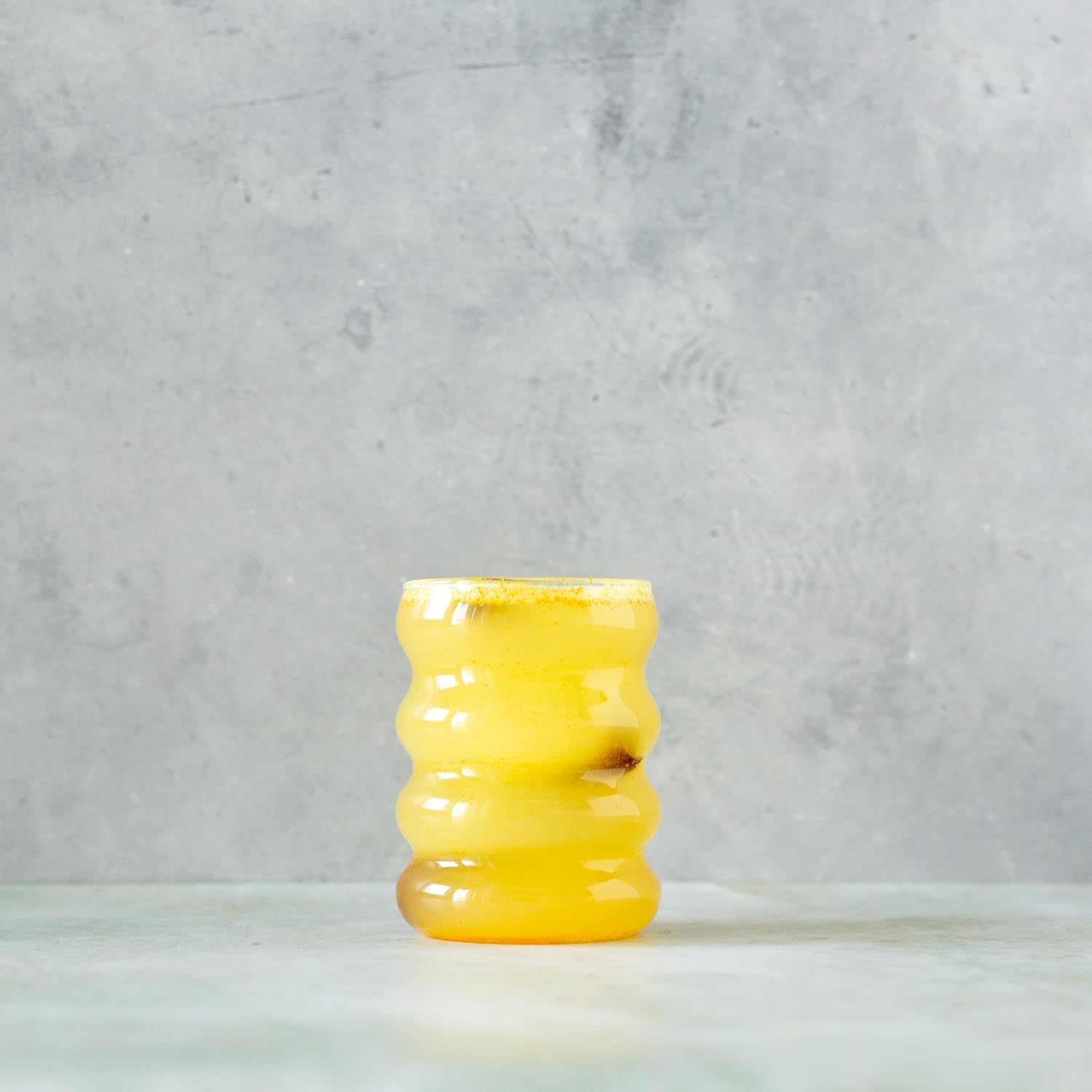 Spoonful of Erbology Organic Turmeric Root Powder on a wooden table