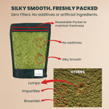Spoonful of EVARA Organic Moringa Powder 349g on a wooden surface