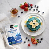 Spoonful of Incas Organic Blue Spirulina Powder on a kitchen counter