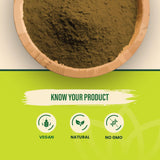 Spoonful of MAPL Pure Amla Powder on a wooden table
