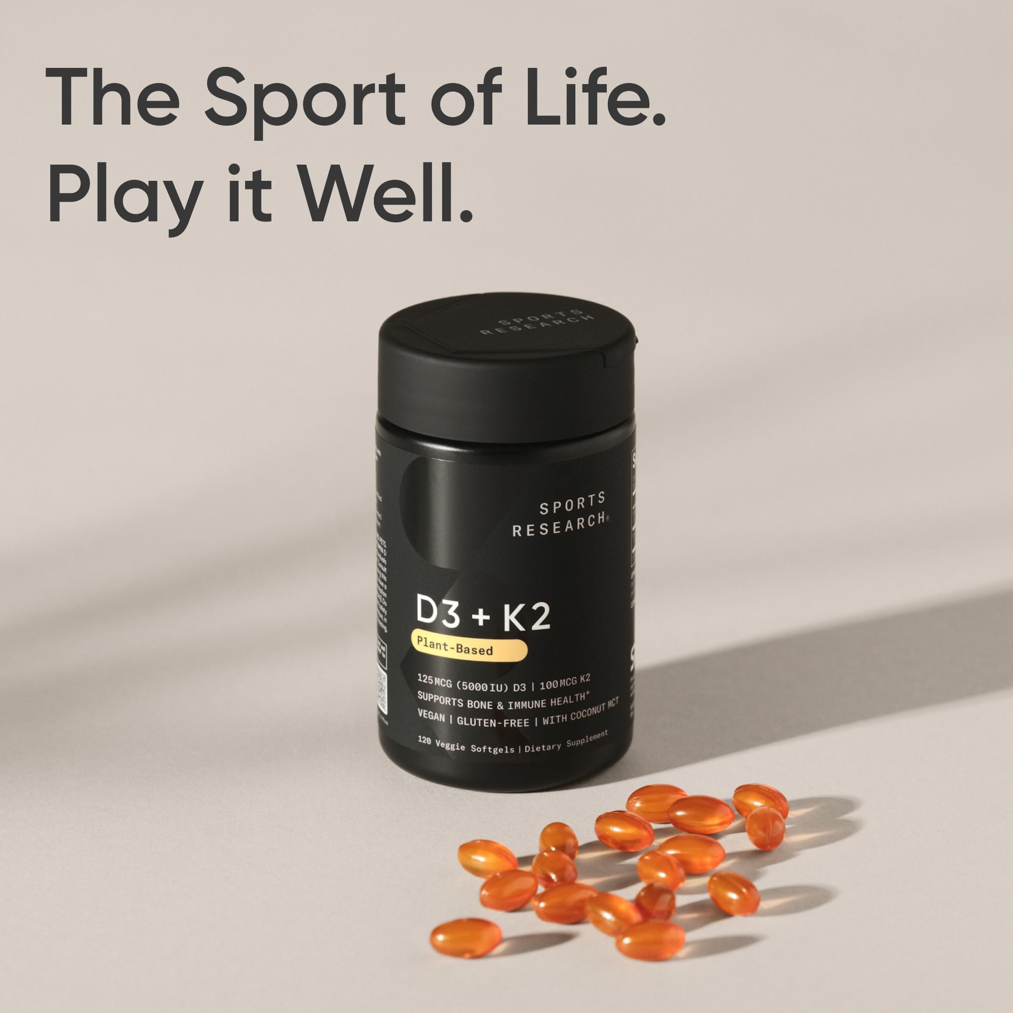 Sports Research D3 + K2 Vegan Softgels with a measuring spoon