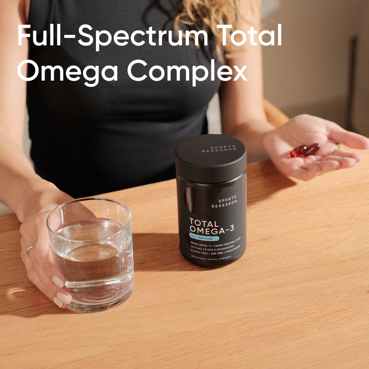 Sports Research Krill Oil Omega-3 Supplement softgels in a hand