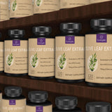 Sunergetic Olive Leaf Extract Capsules on a wooden table