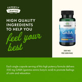 Swanson GABA 500 mg capsules on a wooden table
