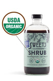 Sweet's Elderberry Organic Shrub 454g with glass of drink