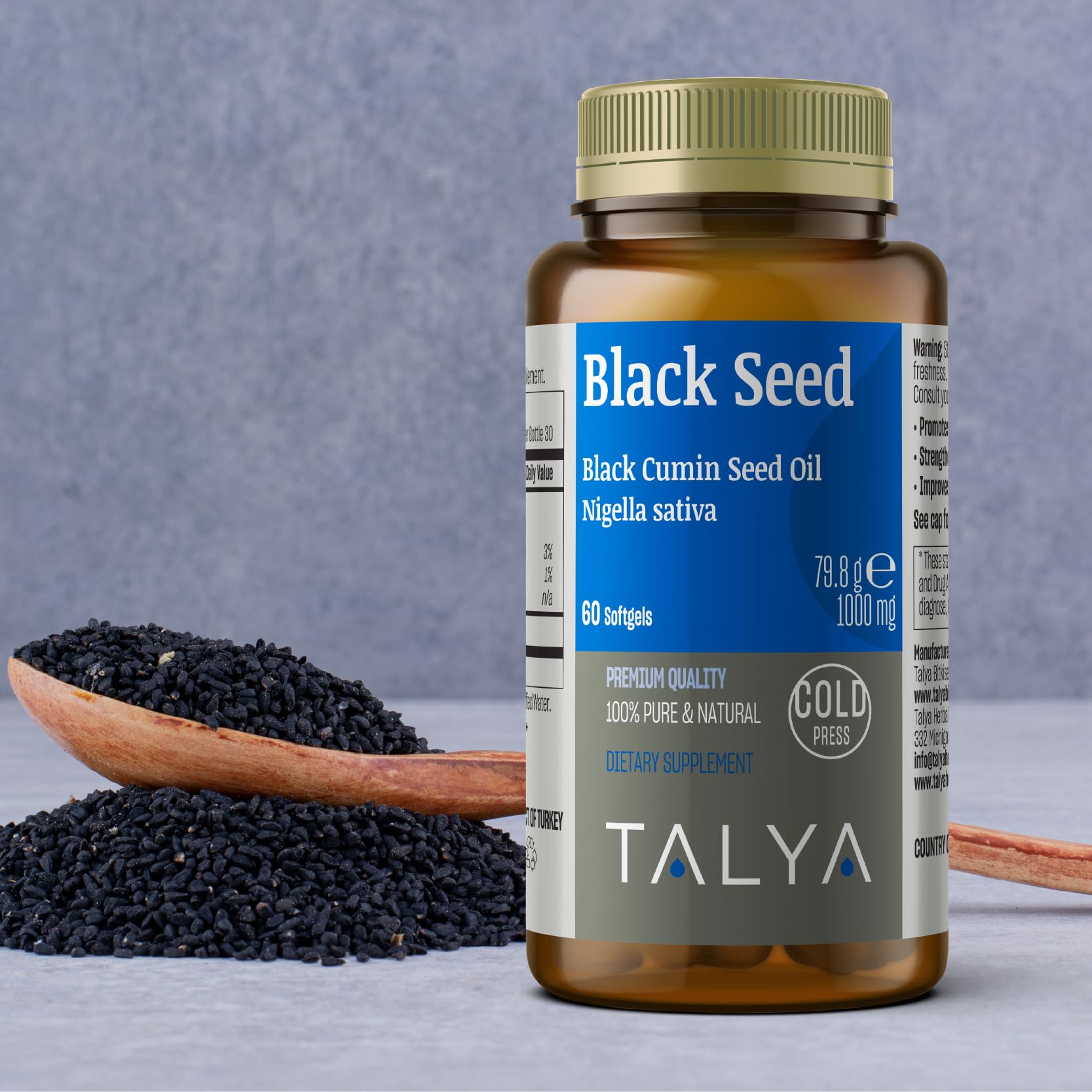 TALYA Black Seed Oil 50ml bottle on a wooden table
