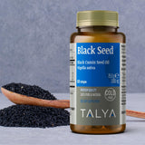 TALYA Black Seed Oil 50ml bottle on a wooden table
