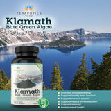 Teraputics Klamath Blue Green Algae capsules on a wooden surface