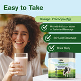 THE MONK Whole Colostrum Powder in a glass of water