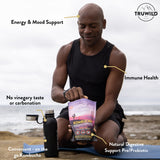 TruWild Kombucha Powder 227g mixed in a glass of water