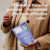 URVI L-Theanine Gummies with a green apple and tea leaves