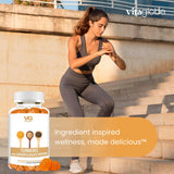 VITA GLOBE Turmeric Gummies lifestyle shot with a glass of water