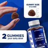 Vitamatic Iron Gummies with a hand holding the bottle