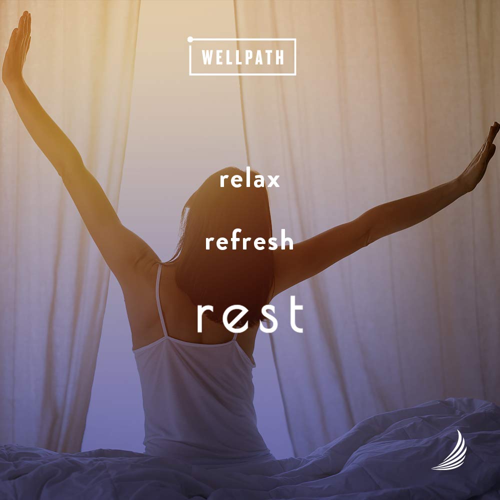 WellPath REST Sleep Supplement capsules in hand