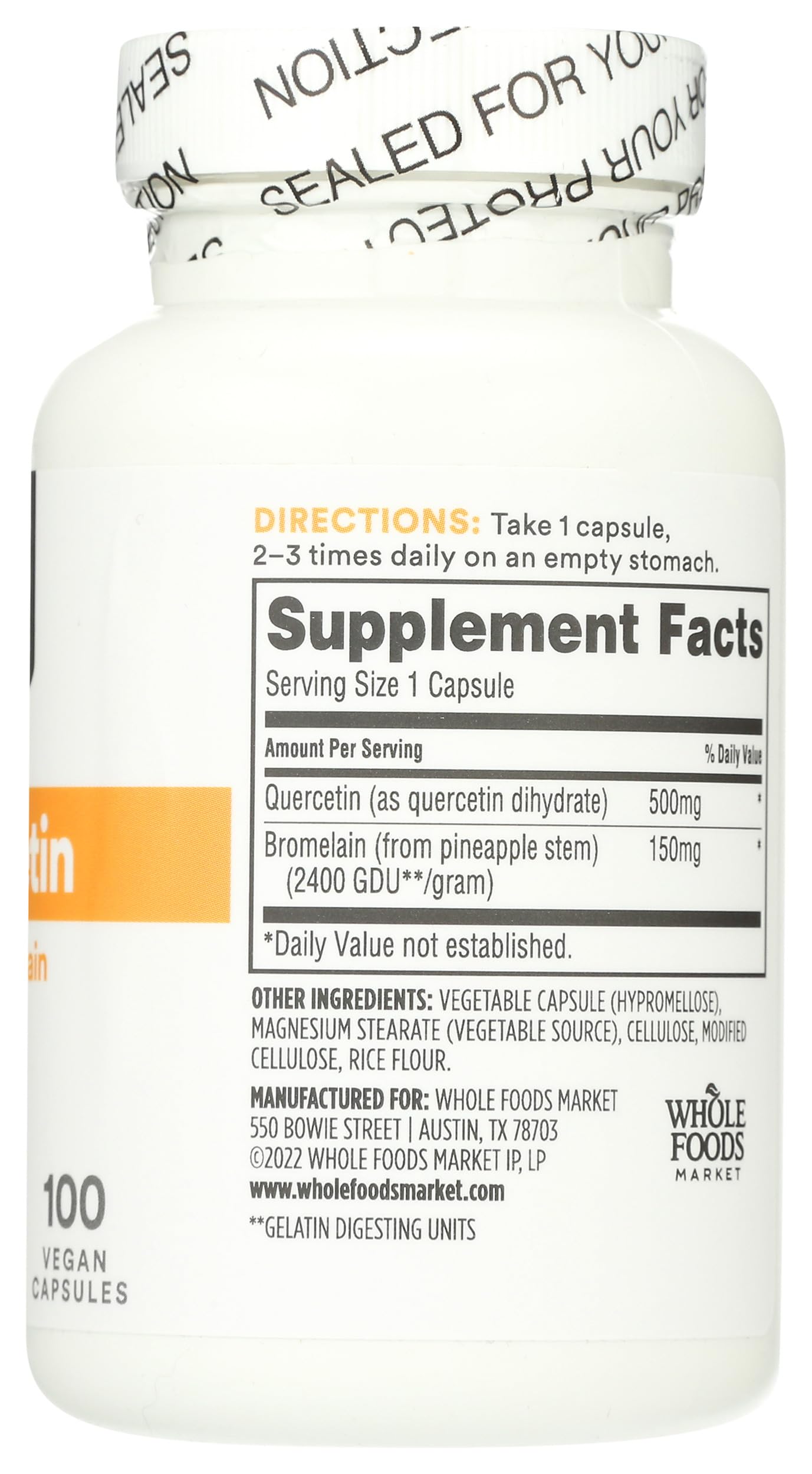 Whole Foods Market Bromelain Capsules on a wooden table