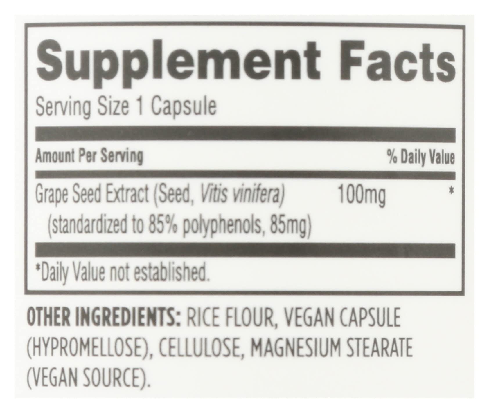 Whole Foods Market Grape Seed Extract capsules on a wooden surface