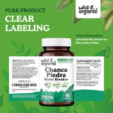 Wild & Organic Chanca Piedra Capsules in a hand