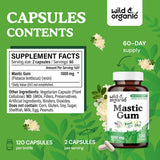 Wild & Organic Mastic Gum Capsules with two capsules on a wooden surface