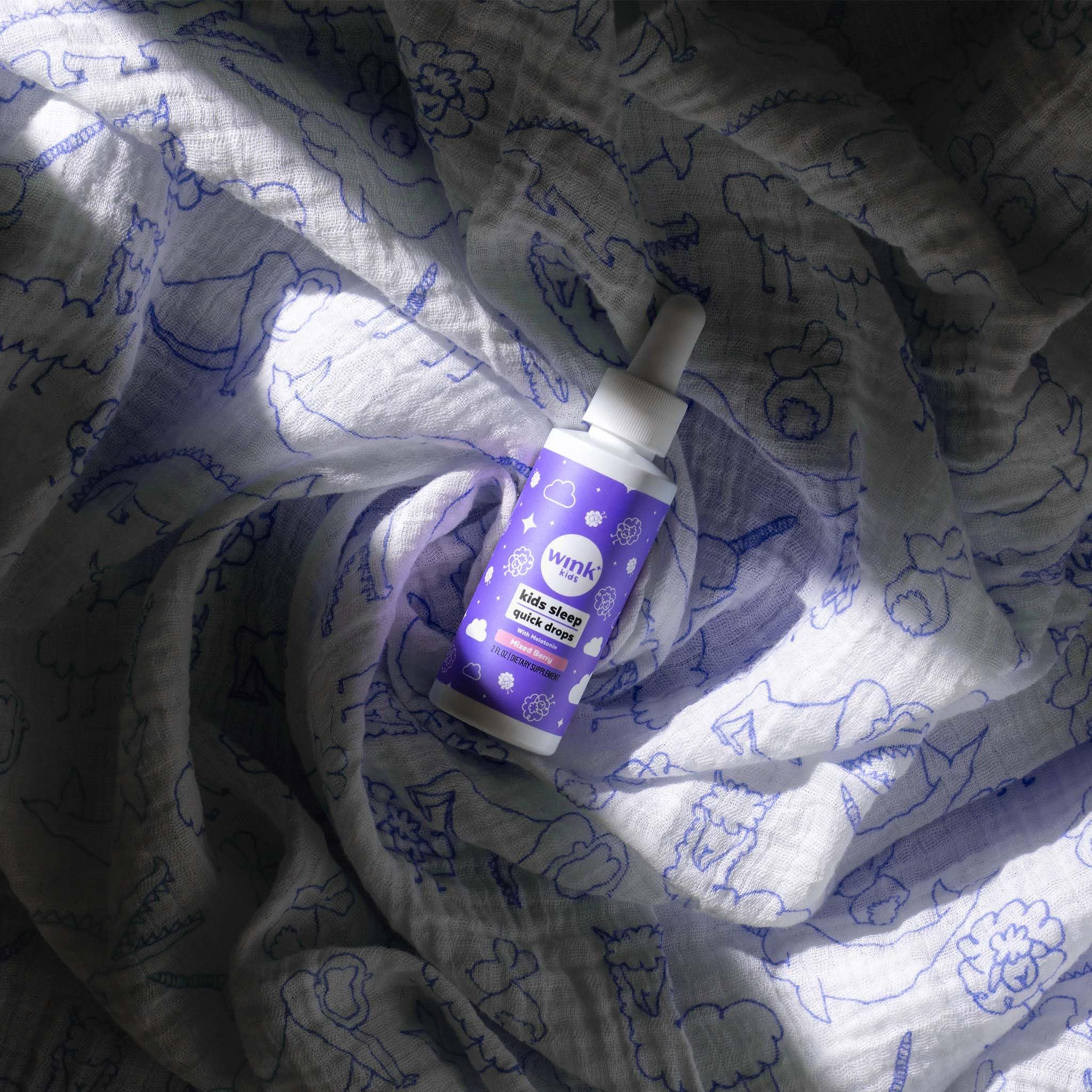 Wink Naturals Kids Liquid Melatonin Drops 1mg with a child smiling
