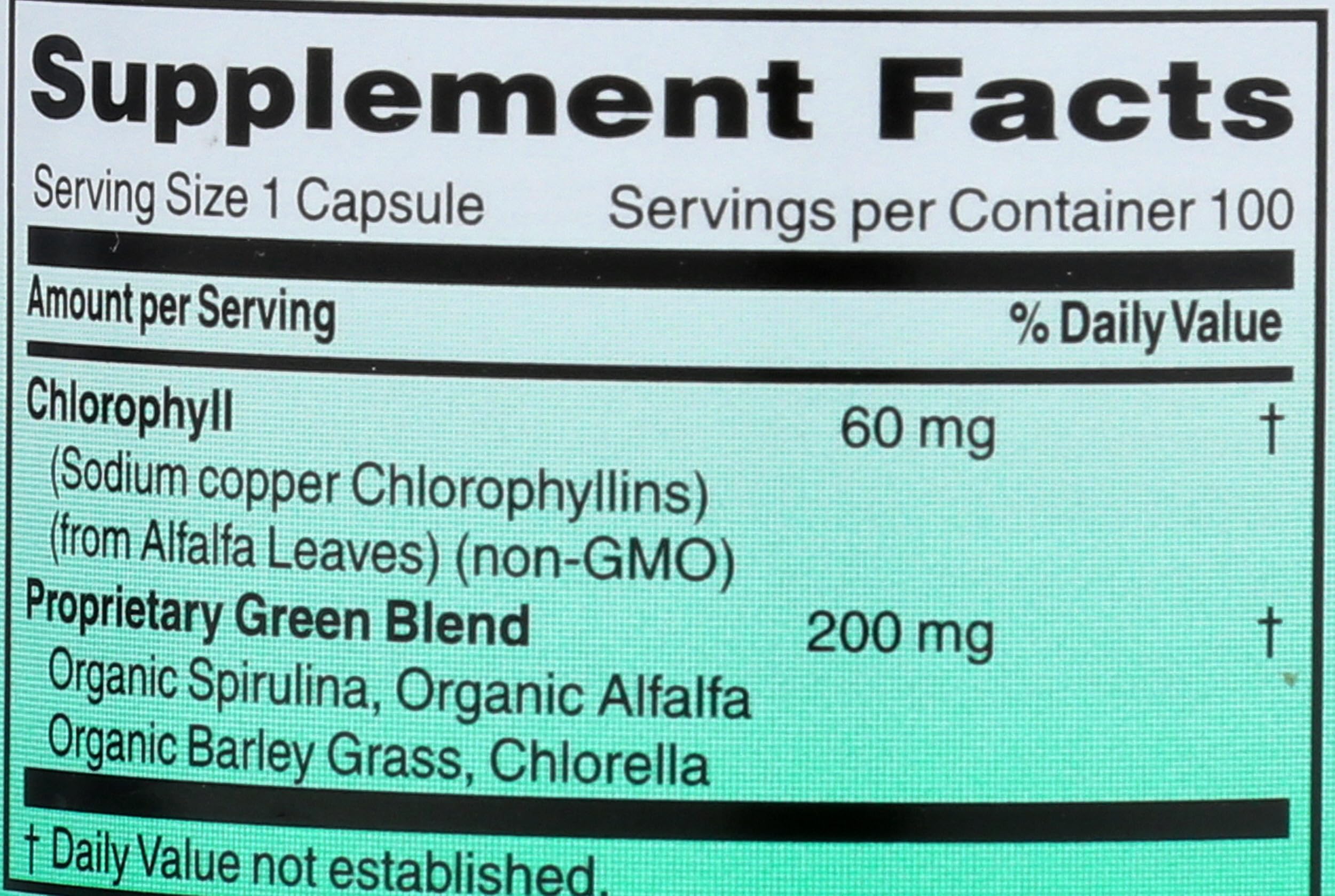 World Organic Chlorophyll 100 mg capsules on a wooden table