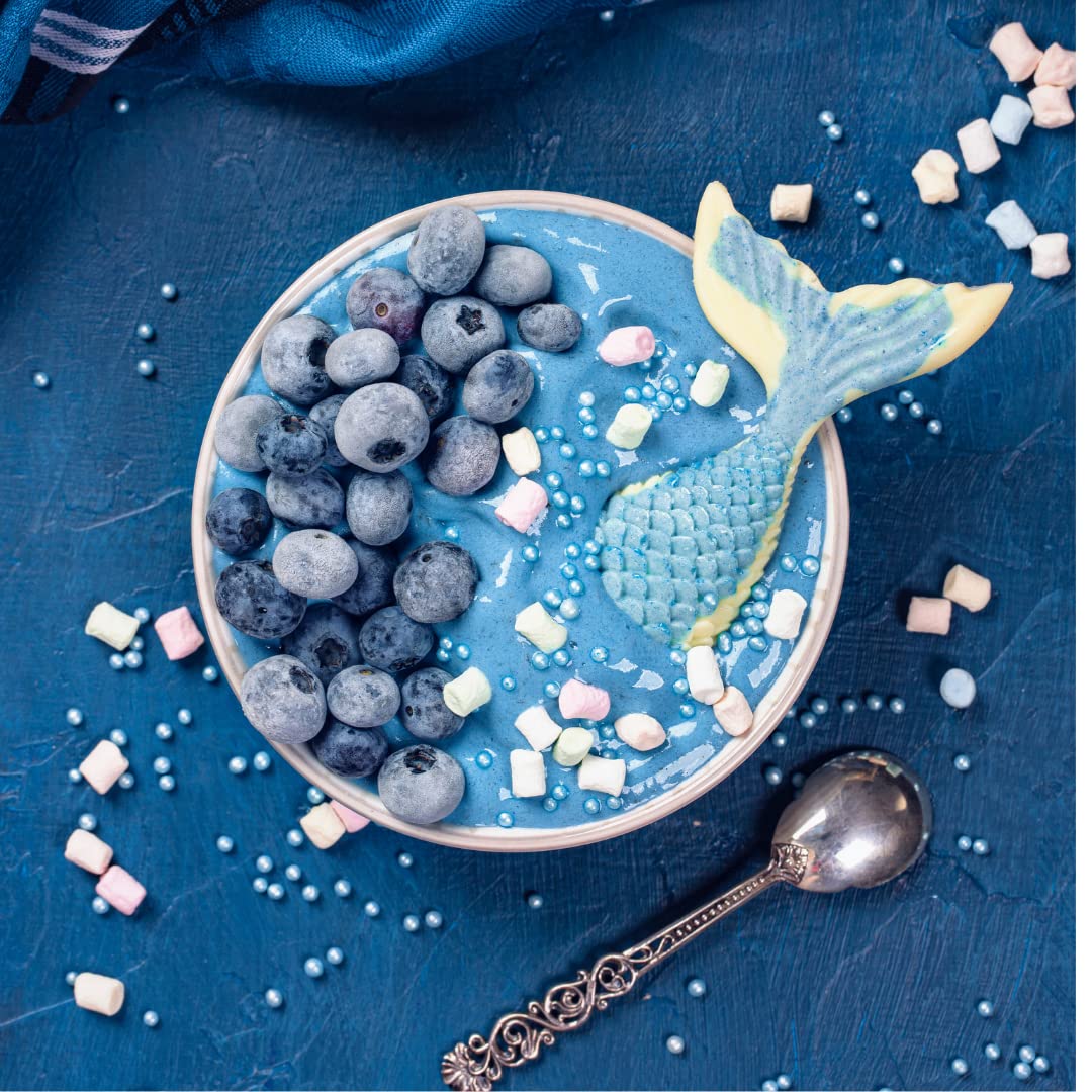 Yogurt topped with blue spirulina and berries