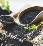 Zatik Black Seed Oil Vegan Softgels with a measuring spoon