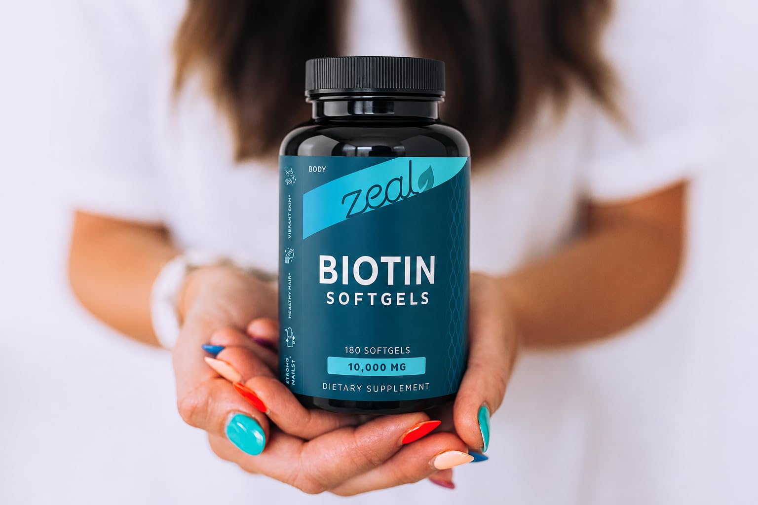 Zeal Naturals Biotin 10000MCG softgels with a measuring spoon